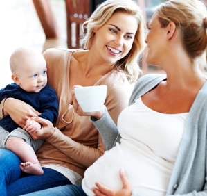 pregnant woman with her friend with child relaxing